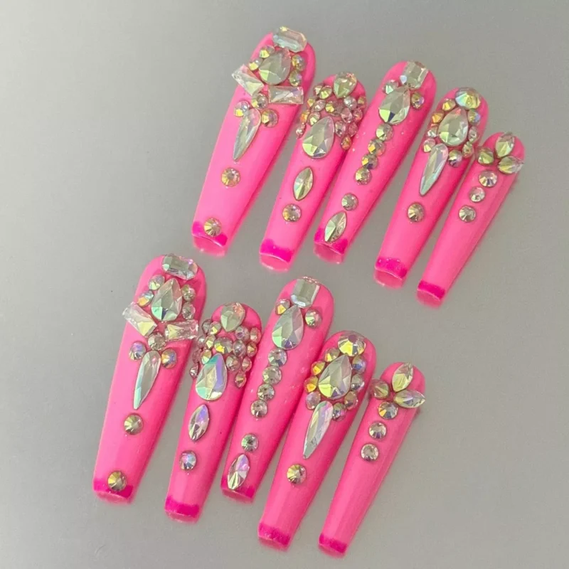 Medium square pink nails with luxury rhinestone layout