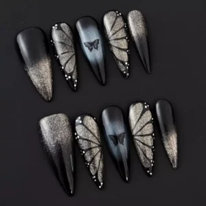 Close-up of glitter detail on black shimmer gradient nails with 3D accents