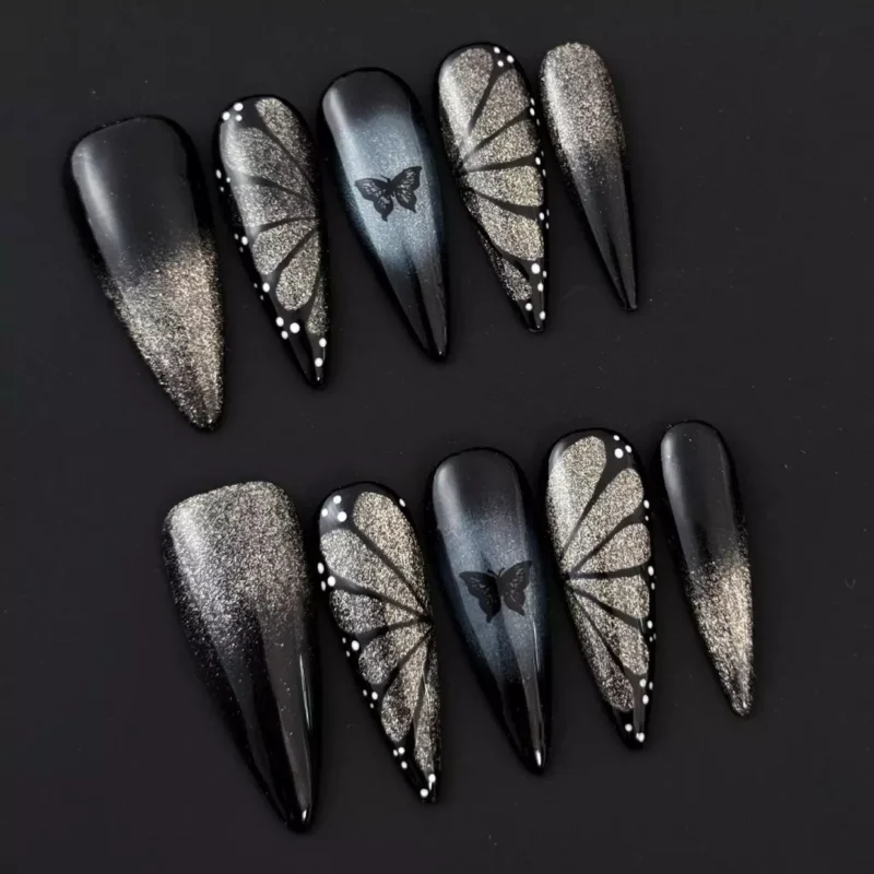 Close-up of glitter detail on black shimmer gradient nails with 3D accents
