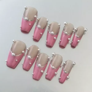 Close-up of Pink Pearl Press-On Nails highlighting glitter French tips and 3D pearls
