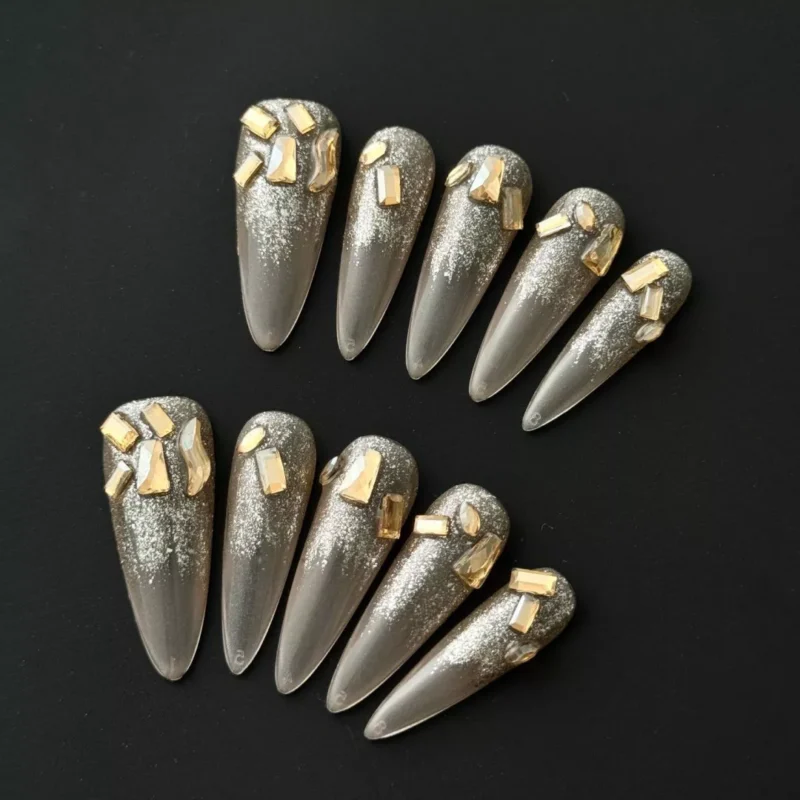 Glitter Gradient Press-On Nails with gold crystal accents, almond shape, nude base