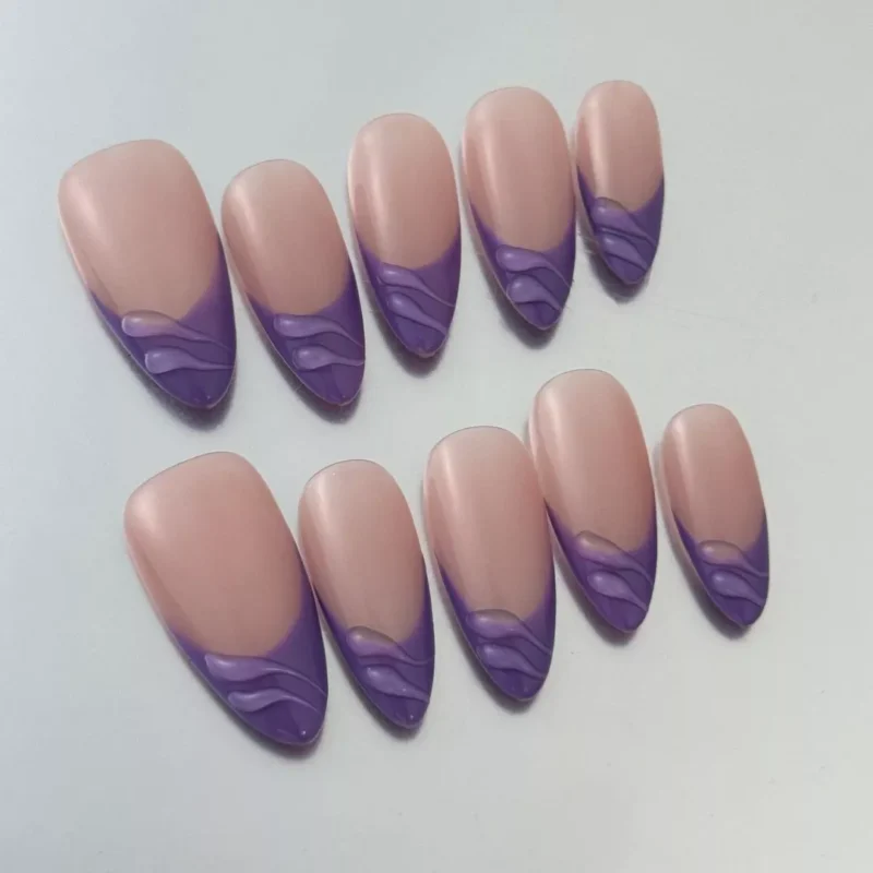 Glossy nude purple nails in almond shape with side wave details – angled side view