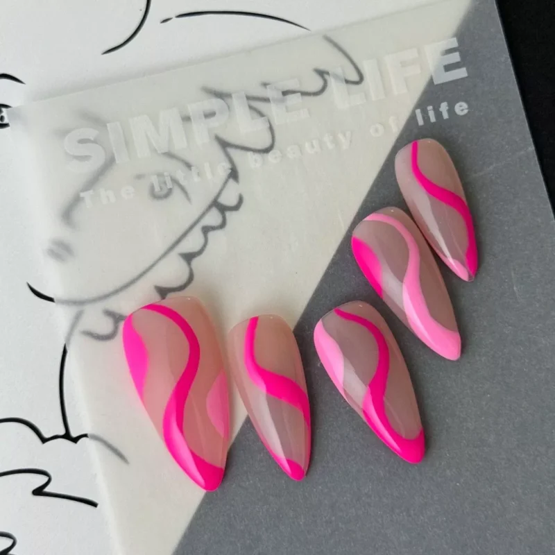 Y2K pink press-on nails with glossy nude and hot pink pattern