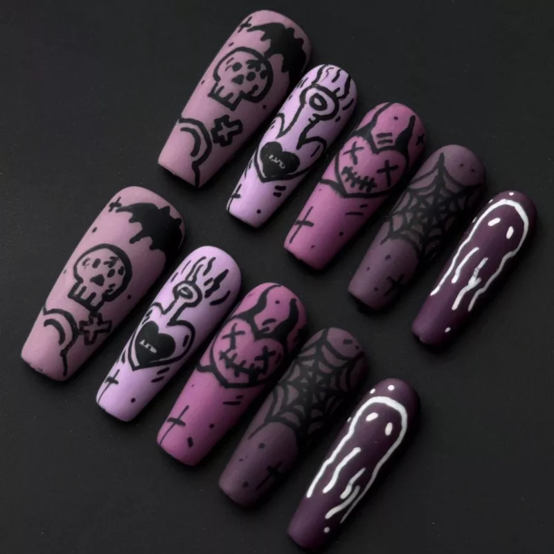 Gothic doodle art press-on nails featuring purple gradient and black spooky icons including ghosts and skulls – front view