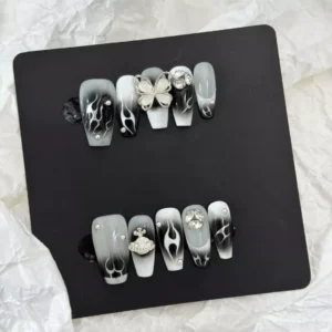 Gothic Flame Nails with dark gradient and star embellishments – flat lay