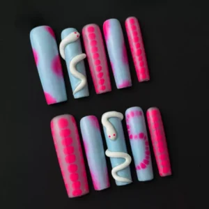Side view of glossy press-on nail with pink and blue ombré and dot line accents