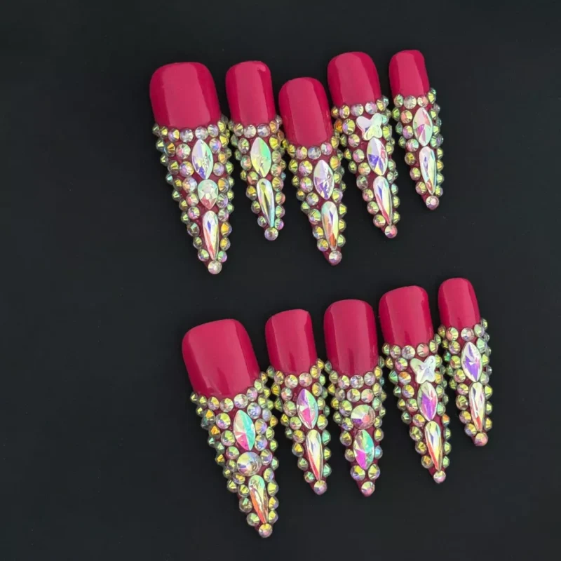 Grapefruit Glam Press-On Nails with full crystal embellishments on red glossy base