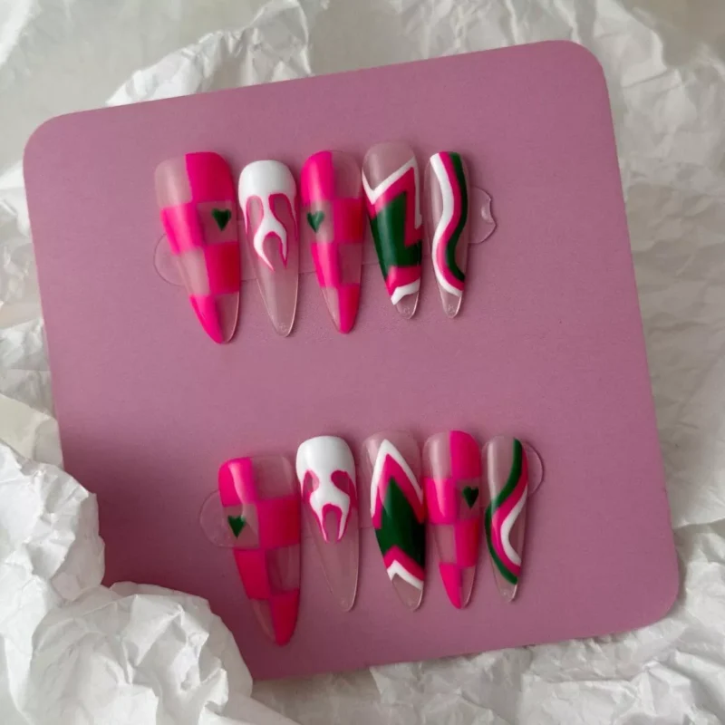 Artistic layout of Y2K pink flame nails with grid and stripe mix – flat lay display