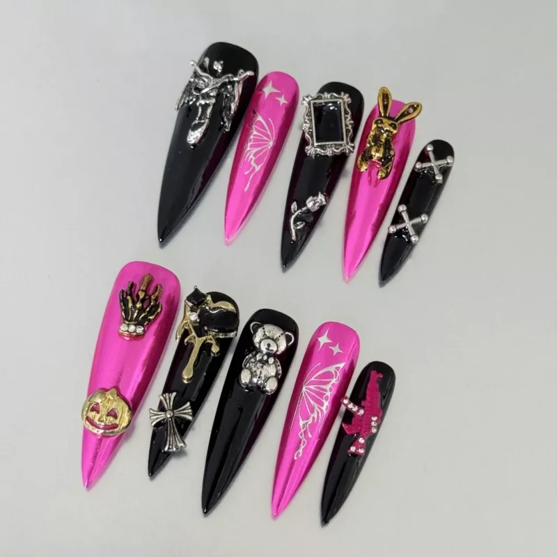 Close-up of Halloween Press-On Nails with vibrant chrome pink and gothic designs