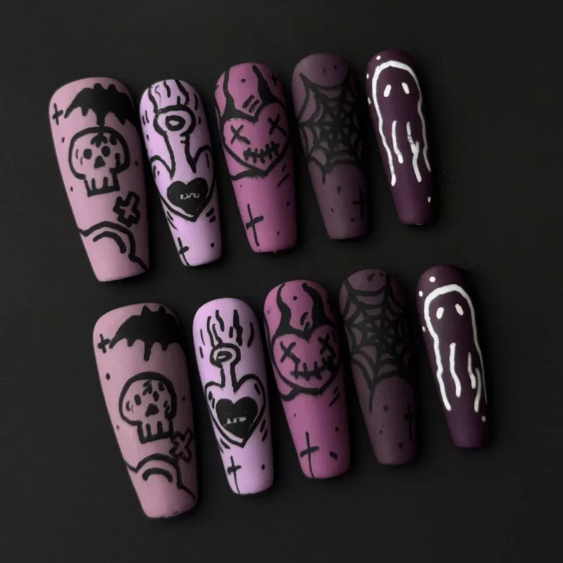 Side view of long stiletto press-on nails with black web, bat, and skeleton drawings