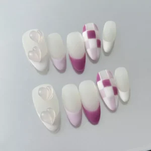 Close-up of matte press-on nail with 3D jelly heart charm and pink and grey color split
