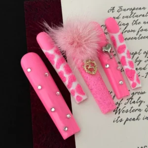 Press-on nails in pink leopard print with glitter and heart embellishments