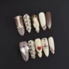 Heart Gem Press-On Nails with snake texture and crystal accents on nude brown base