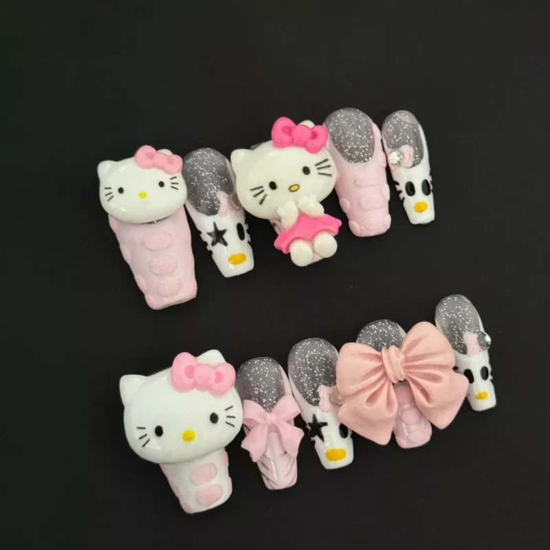 Hello Kitty Charm Press-On Nails featuring pink glitter, 3D bows, and cartoon accents