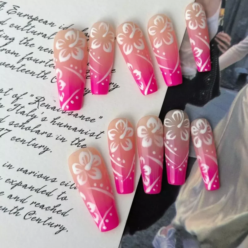 Close-up of tropical-inspired press-on nails with floral motifs