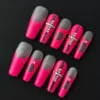 Hot pink press-on nails with matte cross design and crystal embellishments – front view