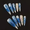 Icy Blue Press-On Nails with silver flame tips and crystal accents – front view