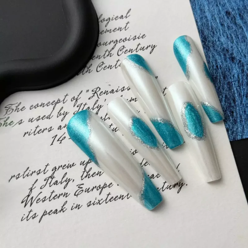 Minimalist press-on nails with icy teal chrome wave pattern over pearl base