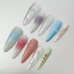 Close-up of 3D floral bubble nail design in iridescent pastel tones with pearl detail