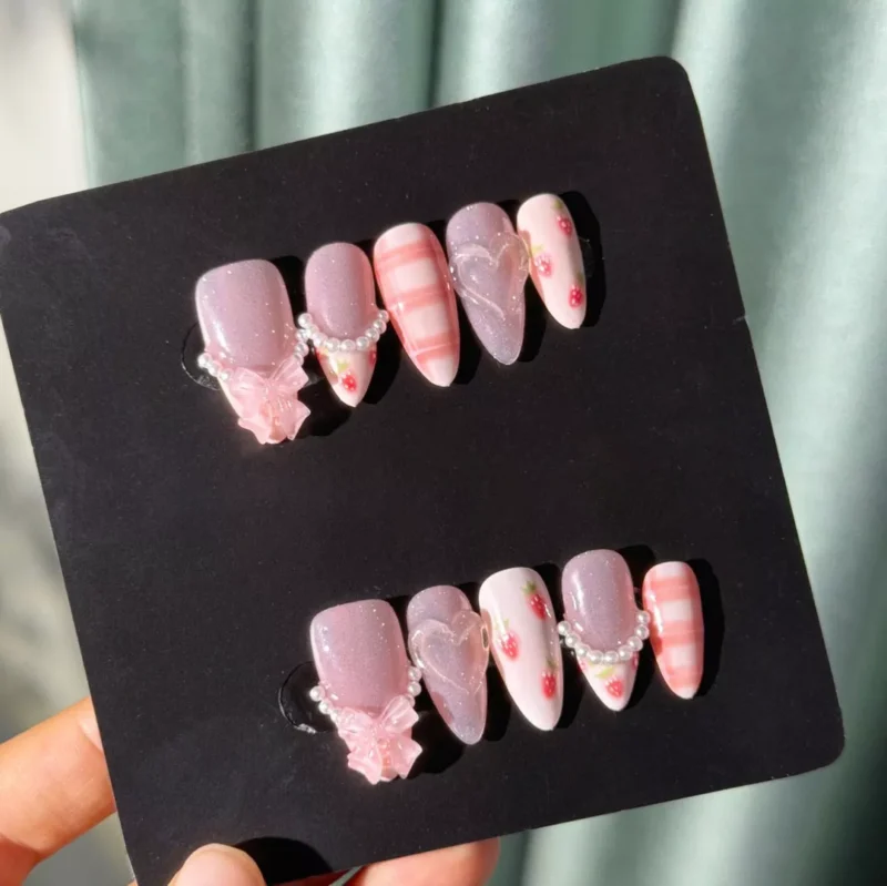 Full set of kawaii press-on nails in box with strawberries and bows