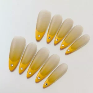 Long almond yellow ombre press-on nails with sparkly accents – full hand styling