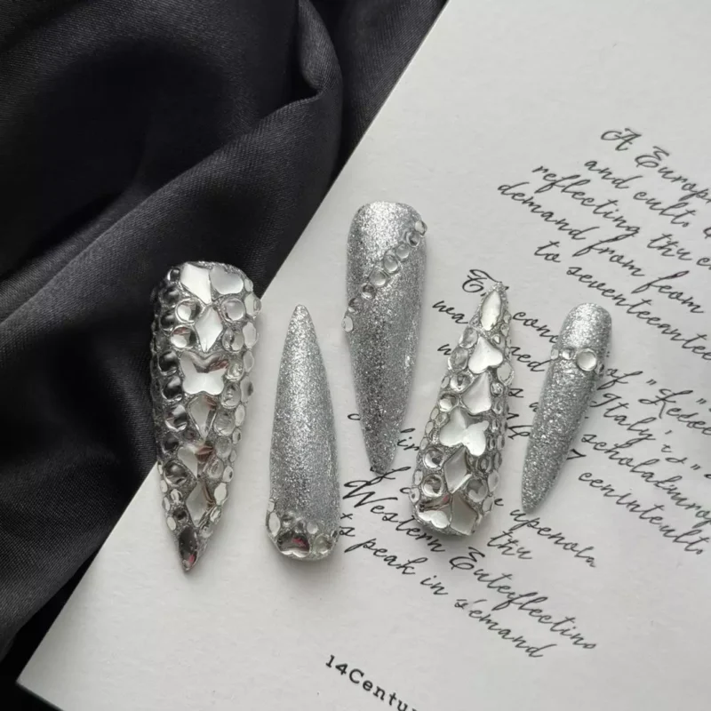 Luxury silver press-on nails with chrome glitter and geometric rhinestones