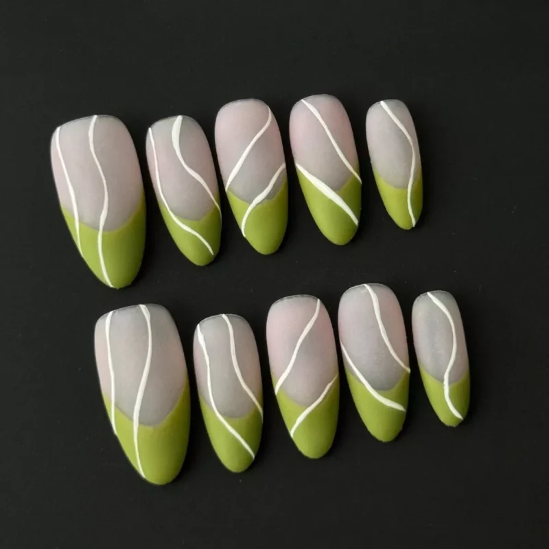 Almond-shaped nude green press-on nails with matte finish and minimalist graphic accents