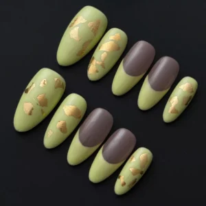 Matte light green press-on nails with taupe French tips and gold foil – flat lay view
