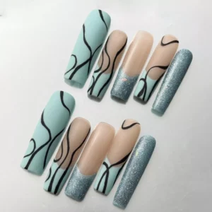 Close-up of matte mint nude nails with abstract black line art and shimmer detail