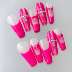 Side angle of bold pink fake nails featuring matte finish and Y2K crystal styling