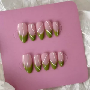 Minimalist nude green nails in almond shape with matte surface and white artistic lines
