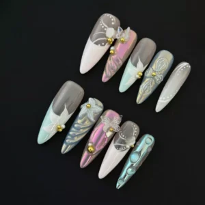 Long almond press-on nails in soft pink, lilac, and mint with floral 3D textures and gold beads
