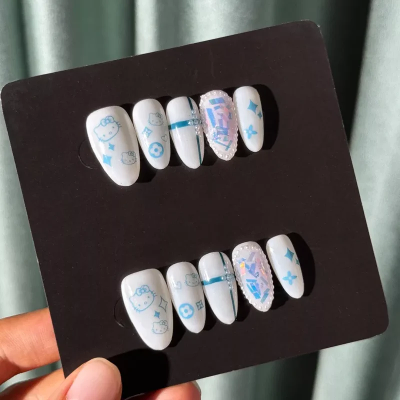 Hand holding White Cartoon Press-On Nails set under natural light