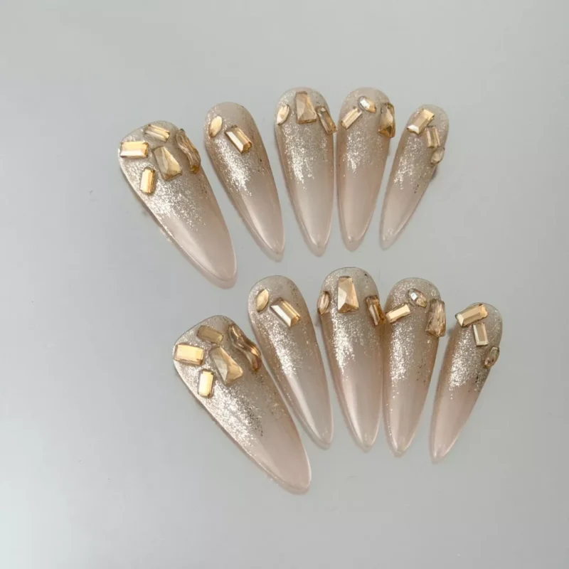 Nude Glitter Press-On Nails with sparkling gold embellishments