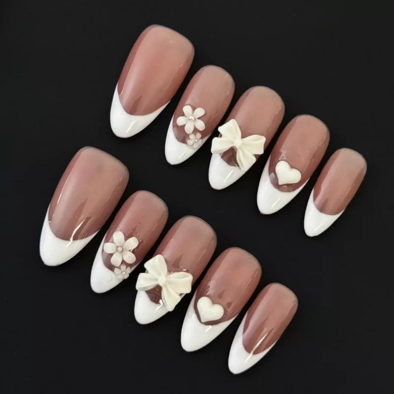 Side view of Nude French Press-On Nails with bow and glitter accents