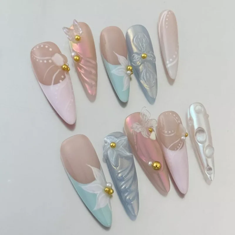 Side angle of pastel chrome nails with multicolor 3D butterflies and pearl-like textures