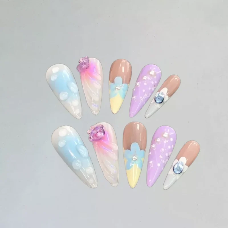 Cute Pastel Gradient Press-On Nails set with floral and crystal accents, white background