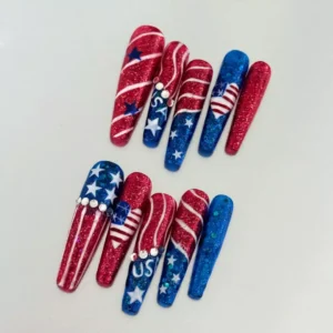 Red and blue coffin-shaped glitter nails with USA letters and American flag hearts