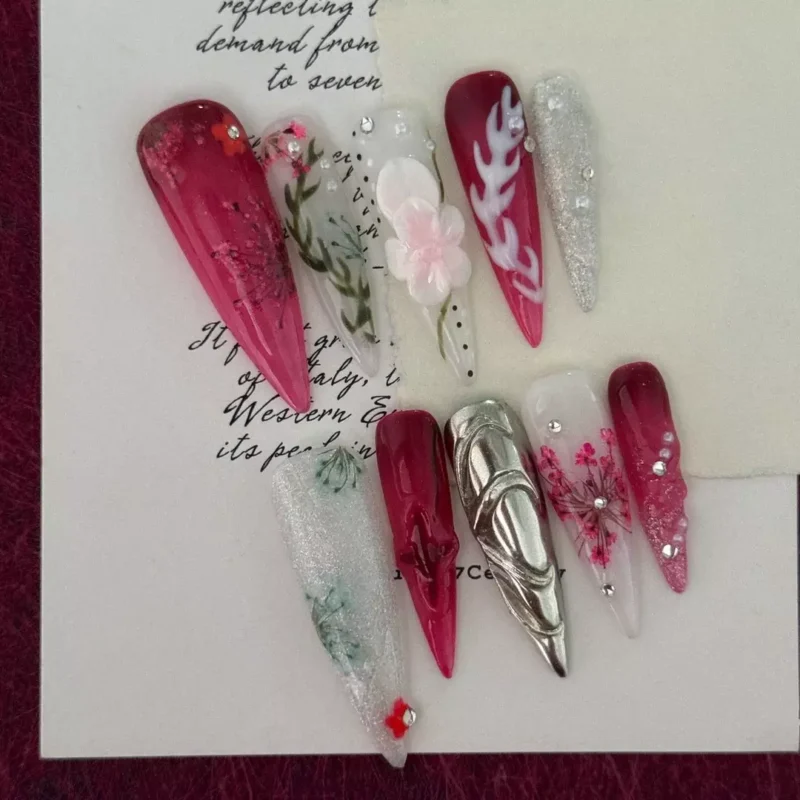 Floral press-on nails with burgundy ombre and silver metallic overlay