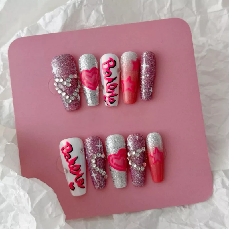 Pink Lettering Press-On Nails with glitter base and star accents – angled layout