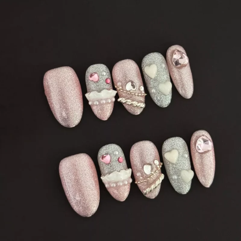 Heart Press-On Nails with glitter finish and 3D heart embellishments on black background
