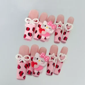 Close-up of Pink Press-On Nails with leopard print and bow detailing