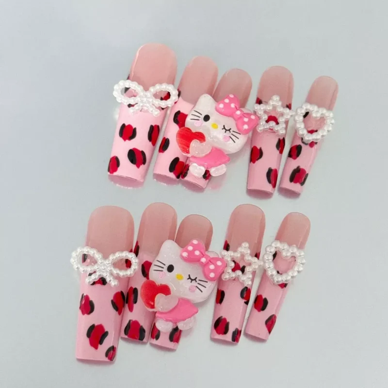 Close-up of Pink Press-On Nails with leopard print and bow detailing