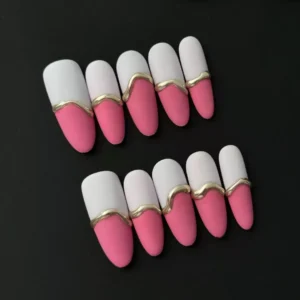 Pink matte press-on nails featuring dual-tone design with gold wave accents – front view