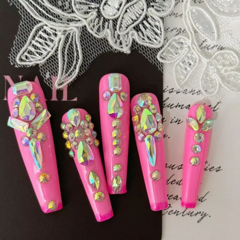 Luxury pink press-on nails with dramatic crystal accents