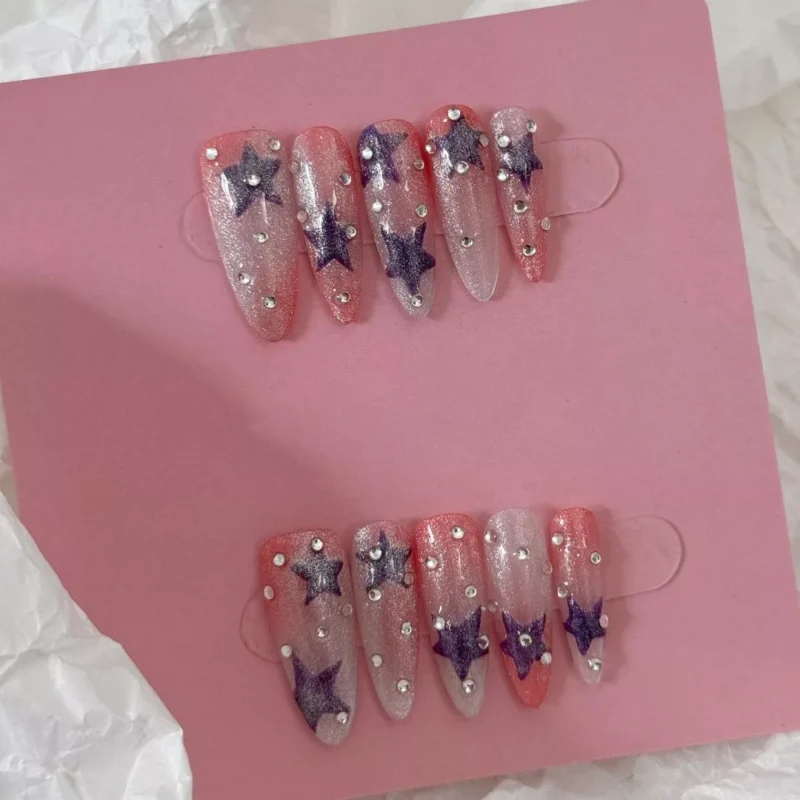 Press-on nails with a pink and purple gradient, starry glitter