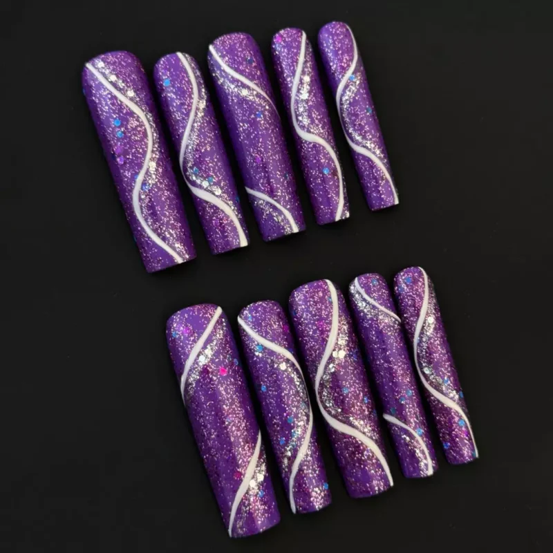 Sparkling purple glitter press-on nails with wavy lines and silver accents,