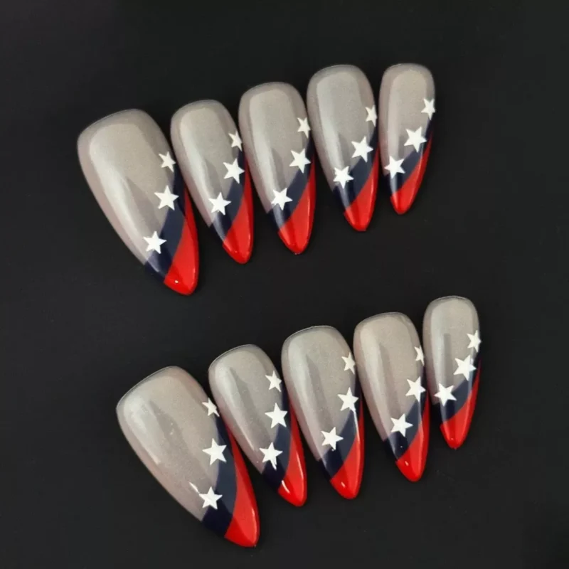 Superstar French Press-On Nails with red and navy tips and star accents on black background