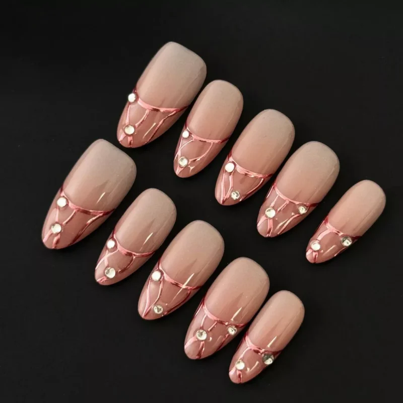 Rose Gold Press-On Nails with nude base and chrome veins, featuring rhinestone accent – front angled view