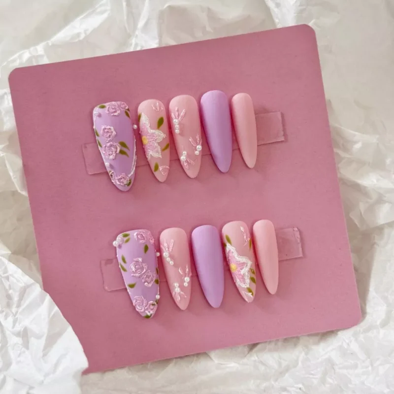 Pastel matte press-on nails with intricate flower sculpting and pearl tips – side view